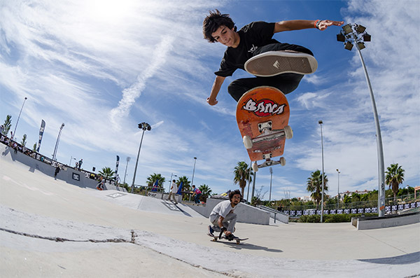 kid on a skateboard flying through the air doing a jump kick flip